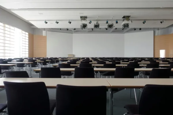 Empty conference room with large whiteboard and projectors