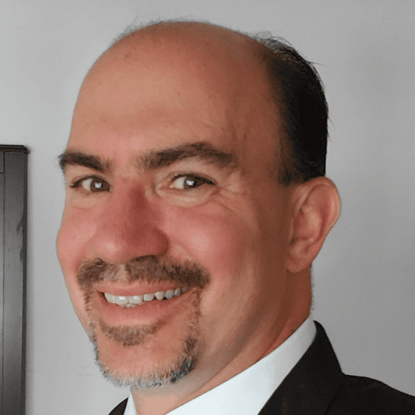 Headshot of John Favilla. Smiling from the neck up