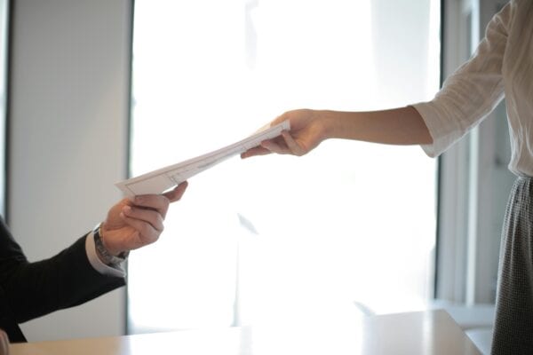 An individual handing over a document.