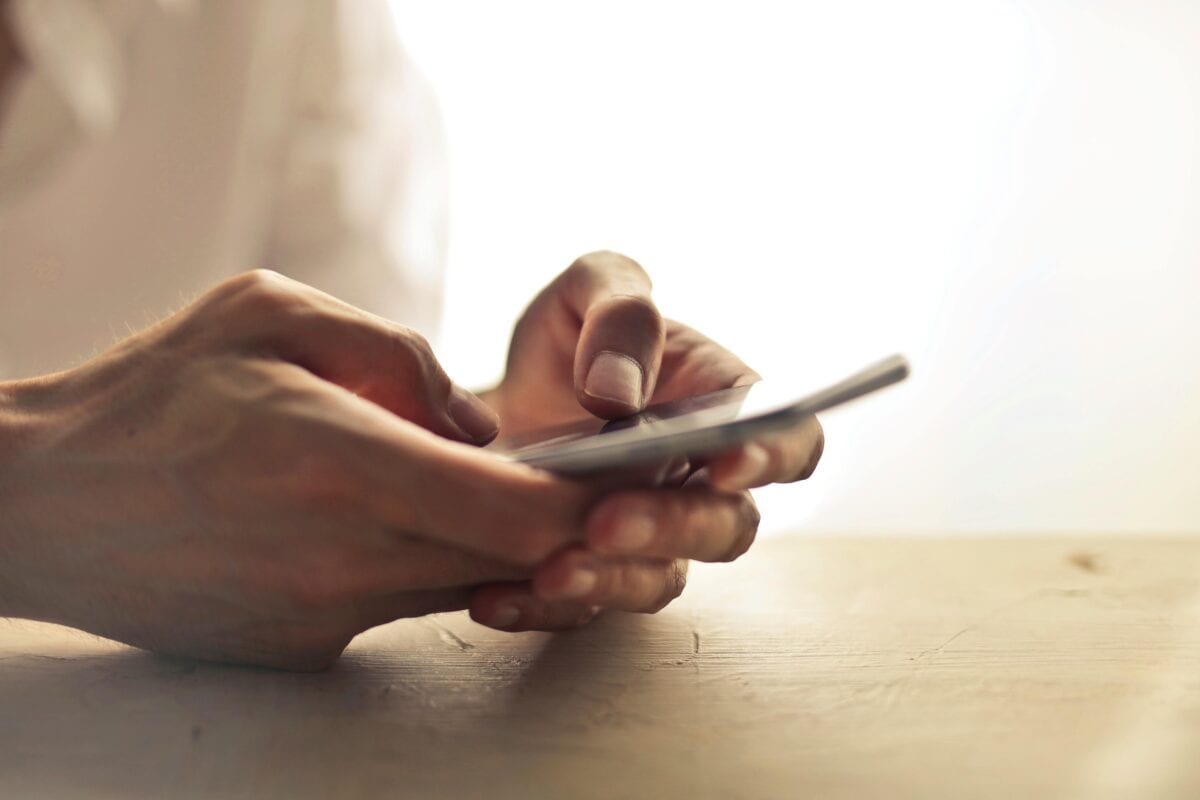 Two hands holding a smartphone.