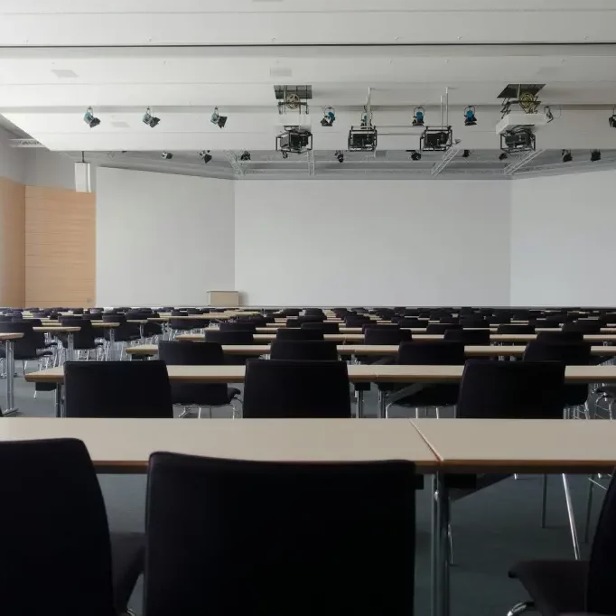 Classroom Empty conference room with large whiteboard and projectors