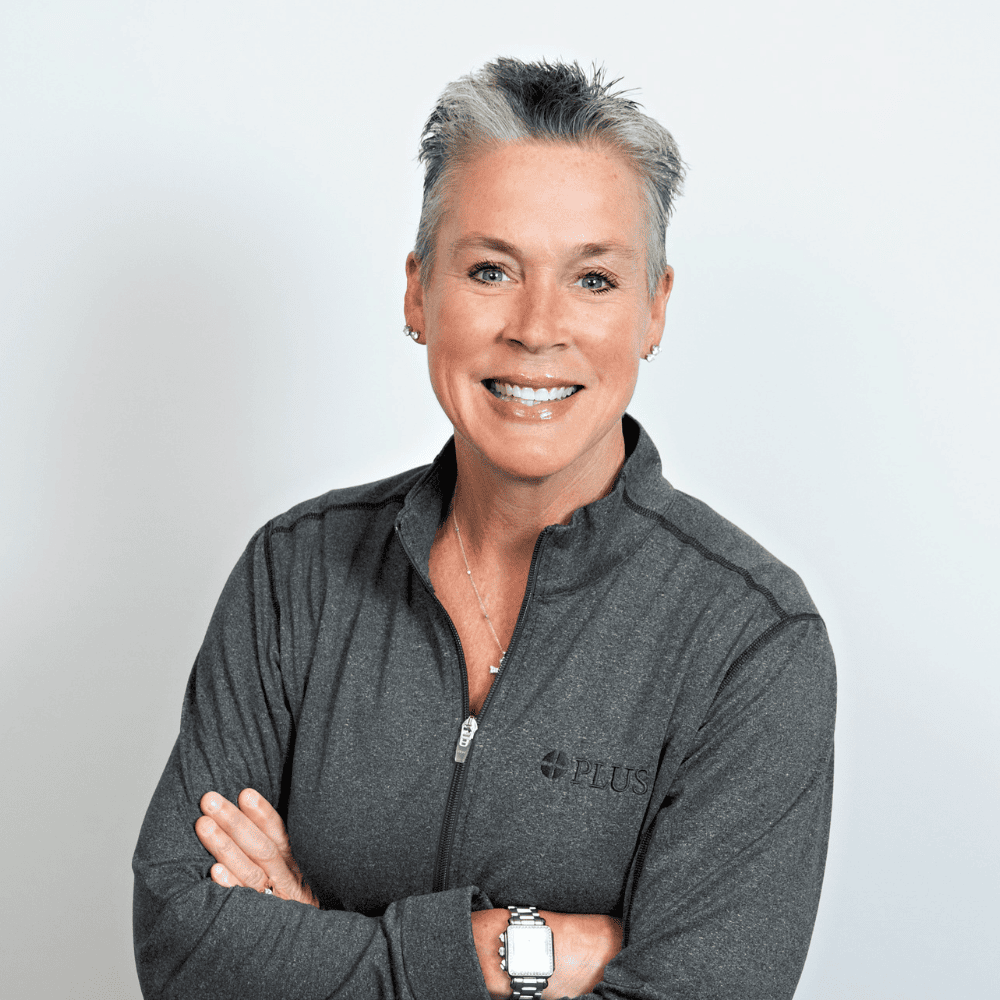 Sue Sheldon Headshot of Sue Sheldon from the shoulders up, smiling, in a gray quarter zip with short gray hair