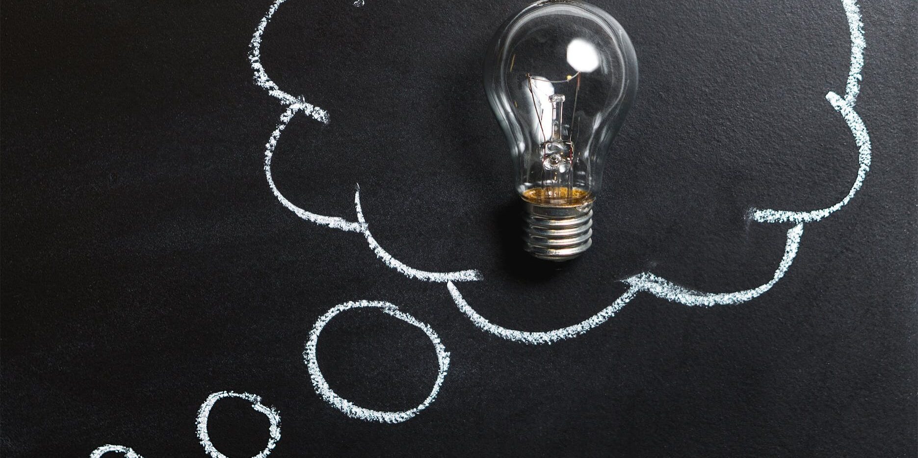 pexels-photo-355952 clear light bulb placed on chalkboard