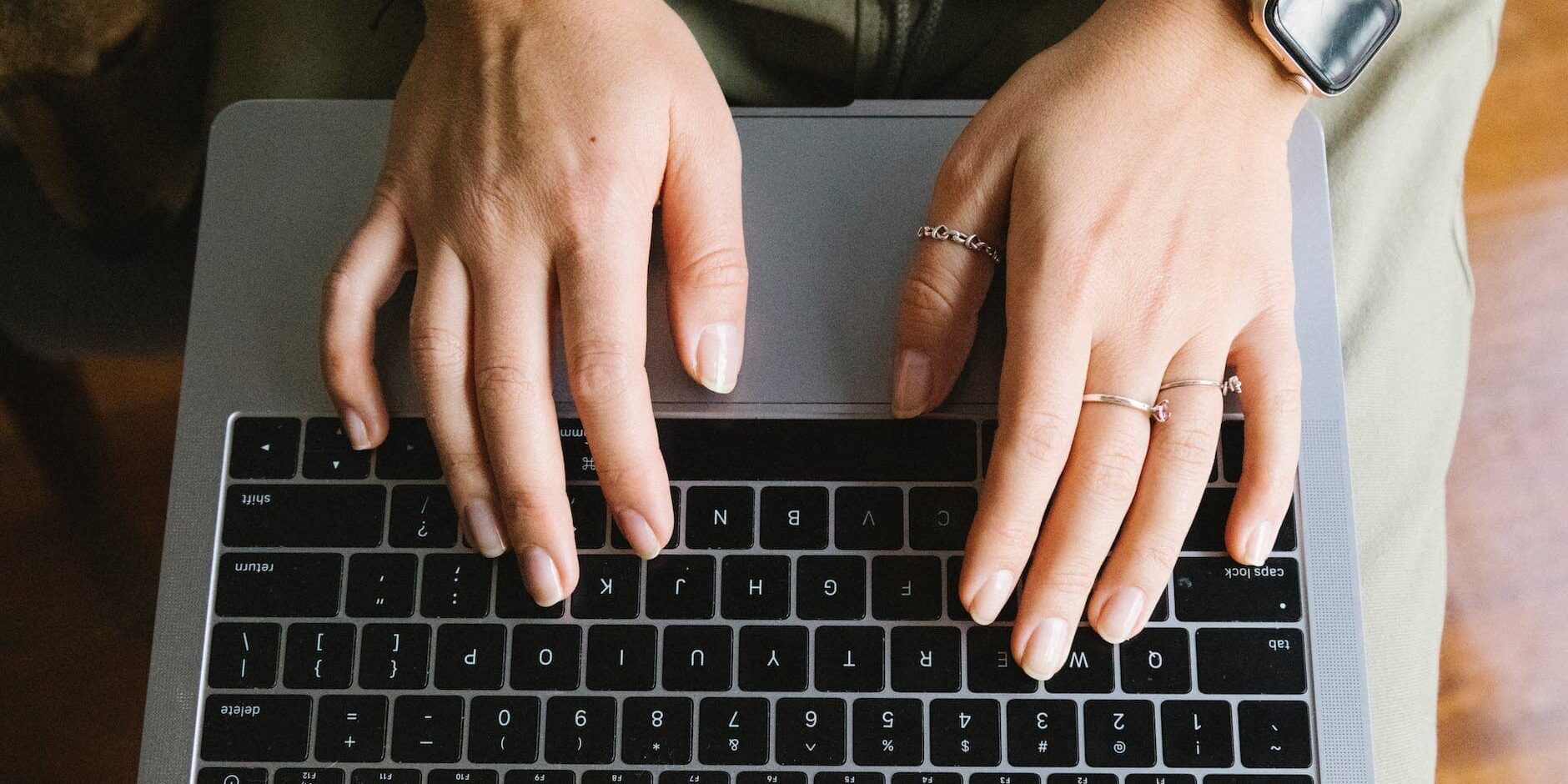 crop unrecognizable woman working on laptop